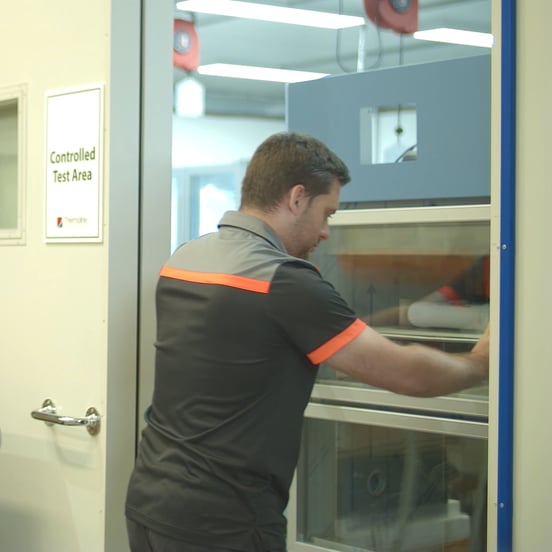worker pushing temperature and humidity cabinet into test room for quality checks