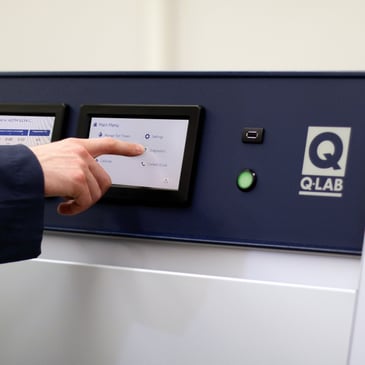 lab techncian programming a quv weathering tester